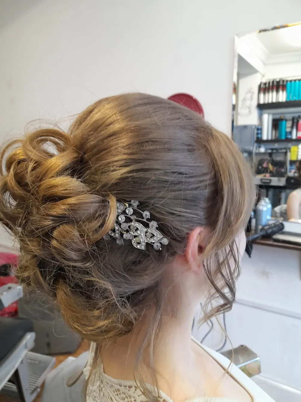 A soft curled updo with a jewelled hair slide